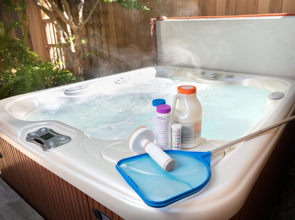 Jacuzzi maintenance items situated on top of the waterfilled jacuzzi
